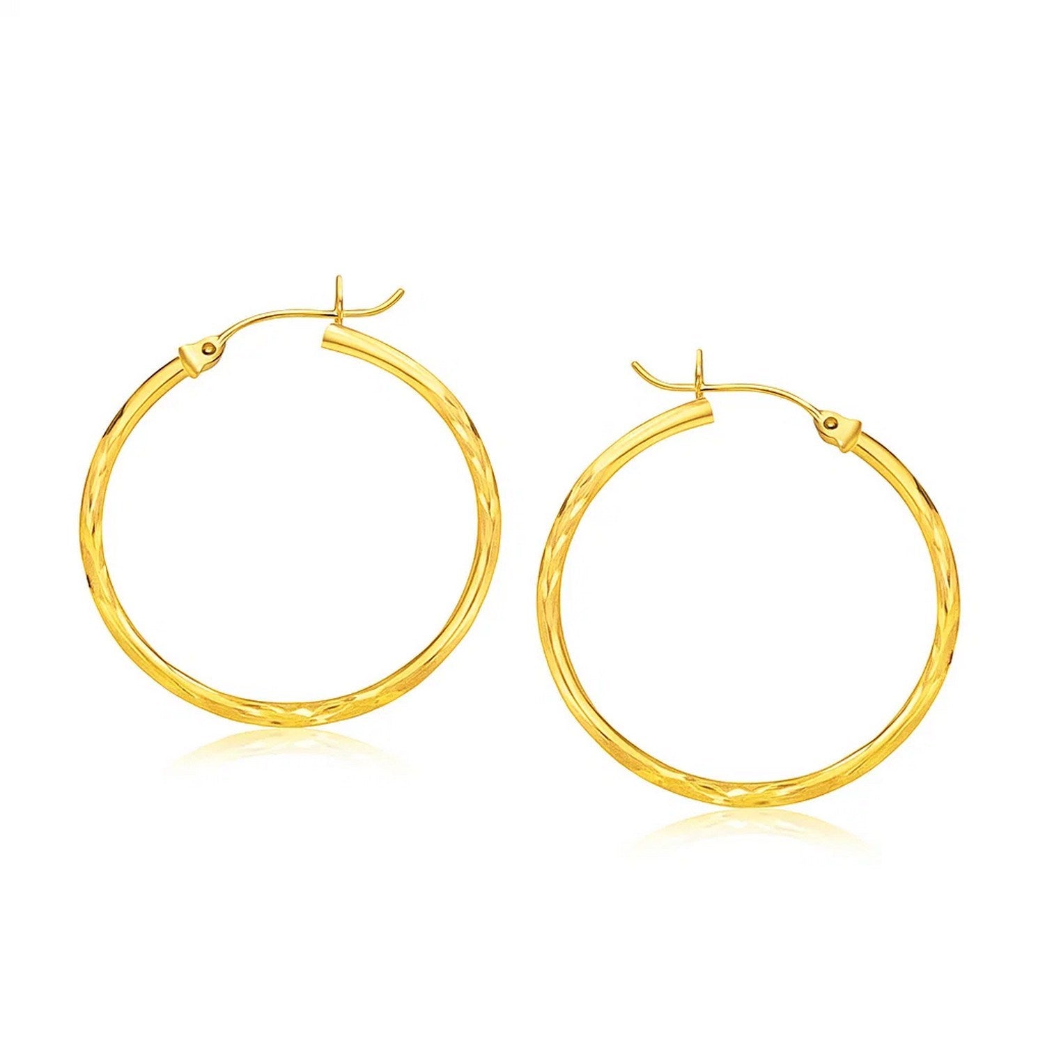Diamond Cut Slender Large Hoop Earrings in 14k Yellow Gold (2x30mm) in a sleek high-contrast midnight luxury editorial style