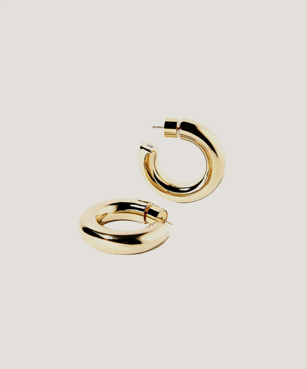 Gold Plated Circular Hoop Earrings in a sleek high-contrast midnight luxury editorial style