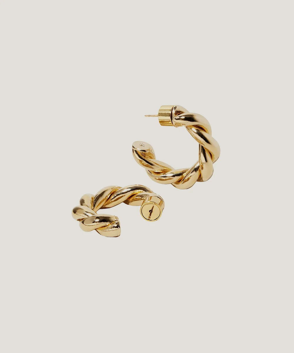 Gold Plated Huggie Earrings in a sleek high-contrast midnight luxury editorial style
