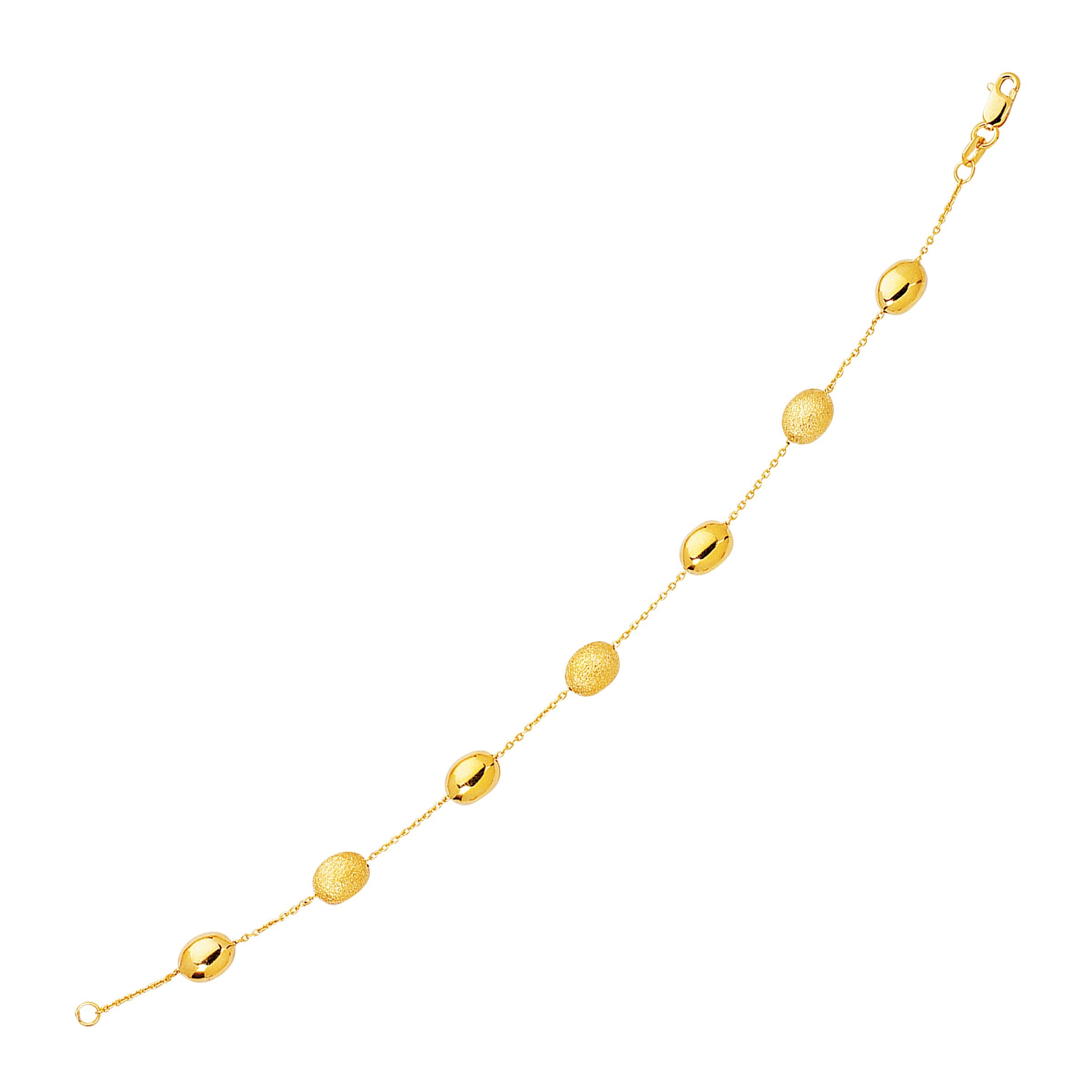 14k Yellow Gold Bracelet with Textured and Polished Pebble Stations (6.35 mm) in a sleek high-contrast midnight luxury editor