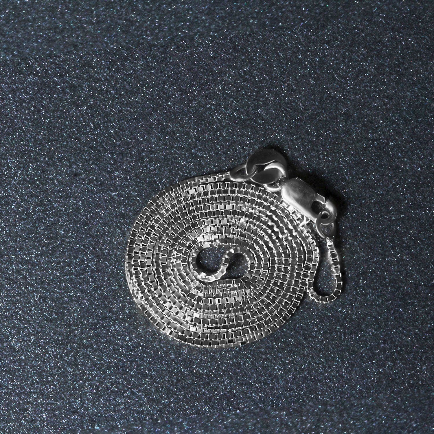 Peelerie jewelry piece in midnight luxury editorial product photo, high-contrast studio lighting