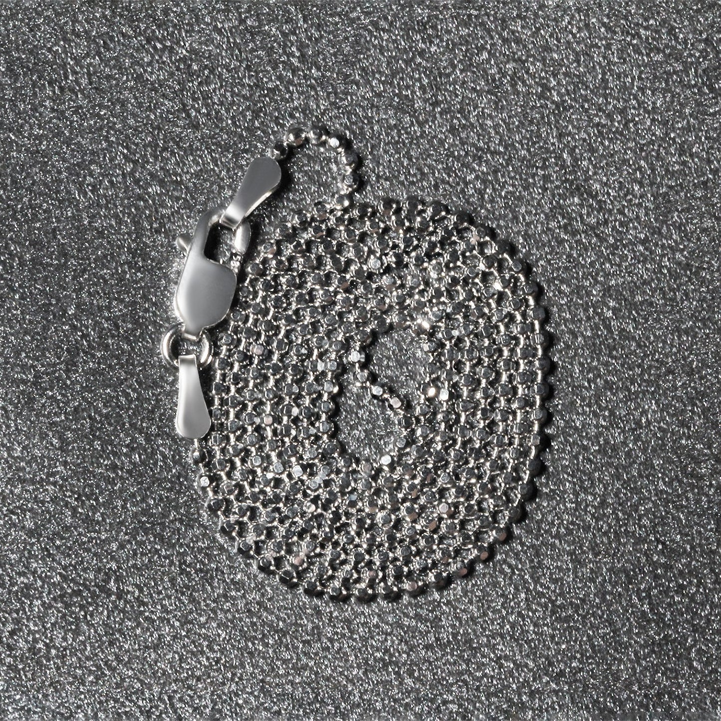 Peelerie jewelry piece in midnight luxury editorial product photo, high-contrast studio lighting