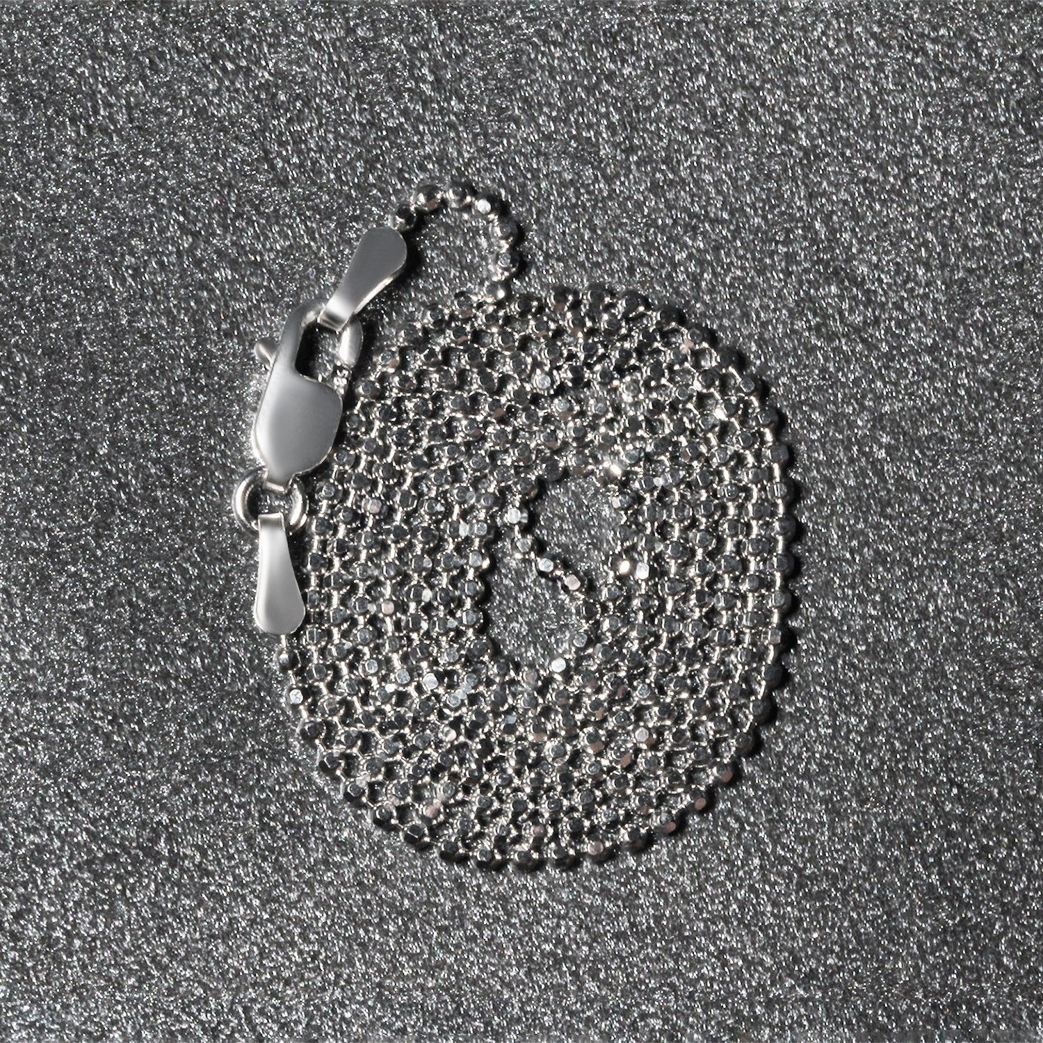 Peelerie jewelry piece in midnight luxury editorial product photo, high-contrast studio lighting