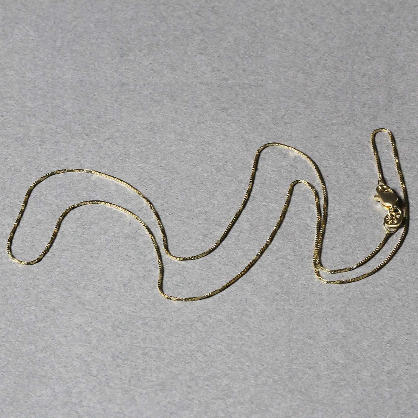 Peelerie jewelry piece in midnight luxury editorial product photo, high-contrast studio lighting