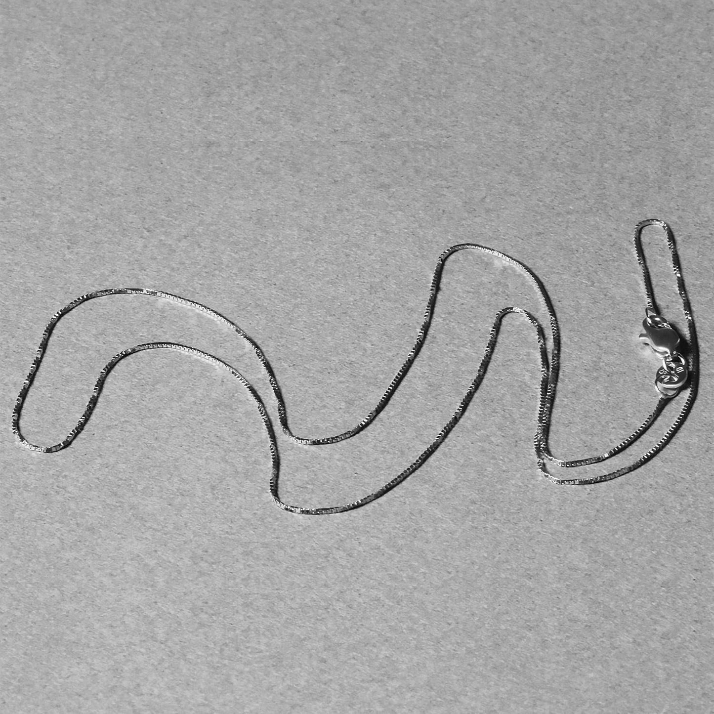 Peelerie jewelry piece in midnight luxury editorial product photo, high-contrast studio lighting