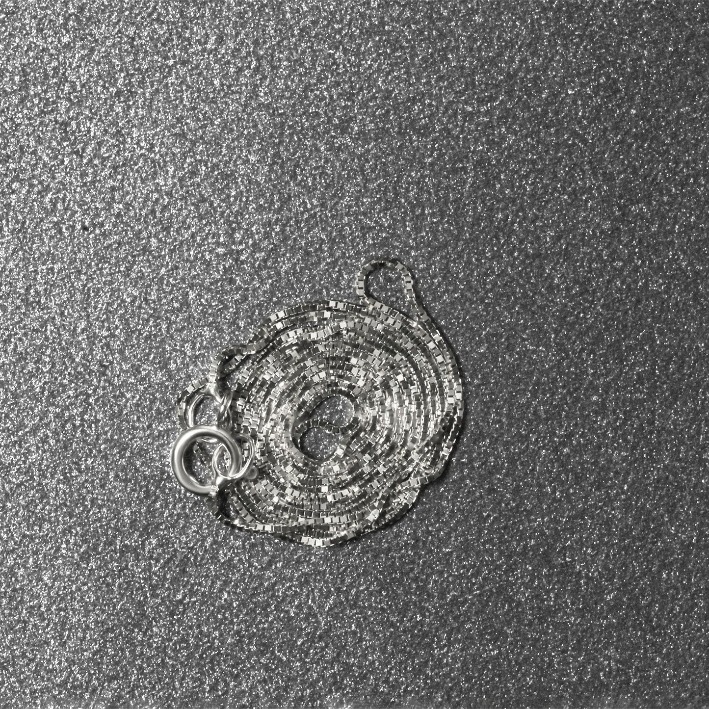 Peelerie jewelry piece in midnight luxury editorial product photo, high-contrast studio lighting