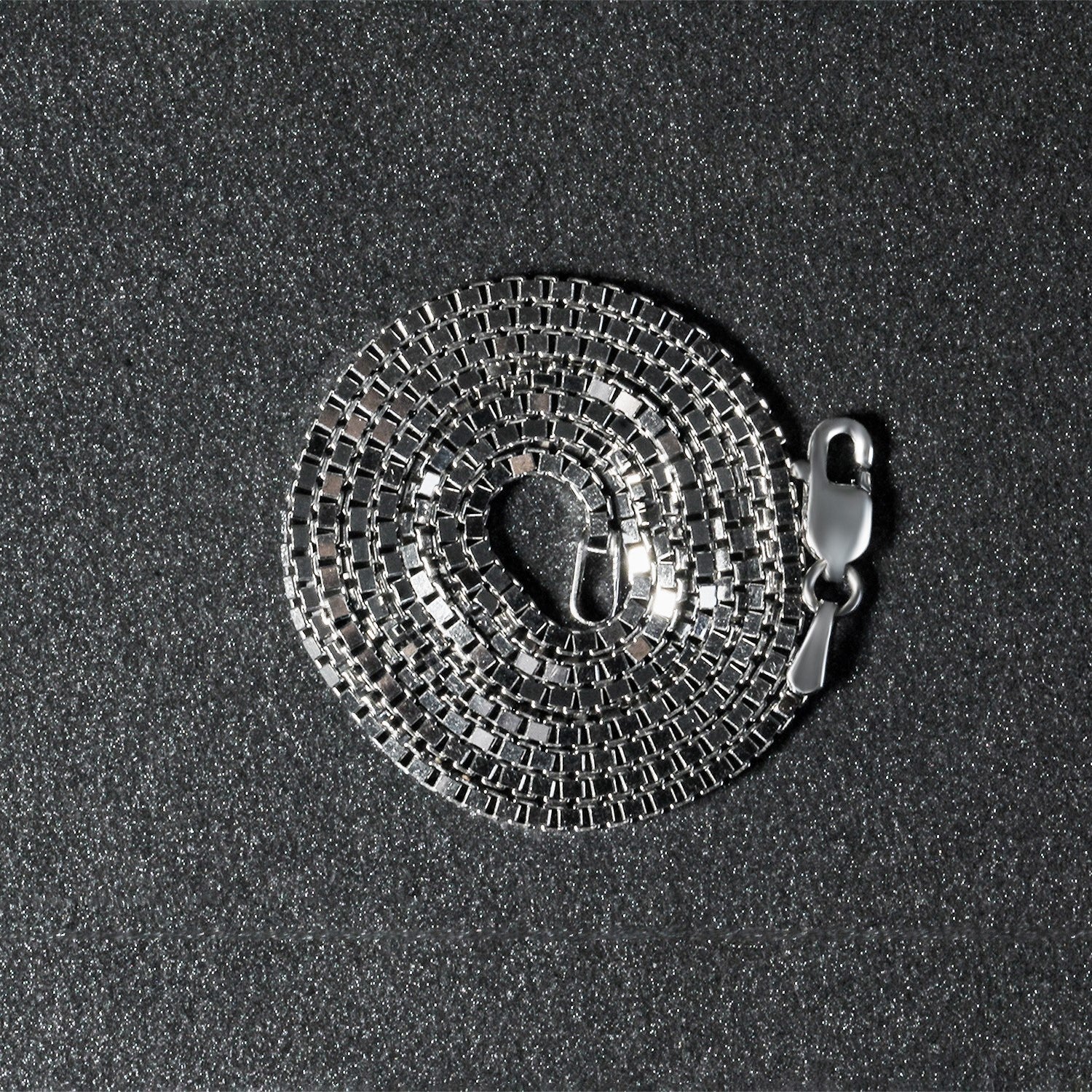 Peelerie jewelry piece in midnight luxury editorial product photo, high-contrast studio lighting