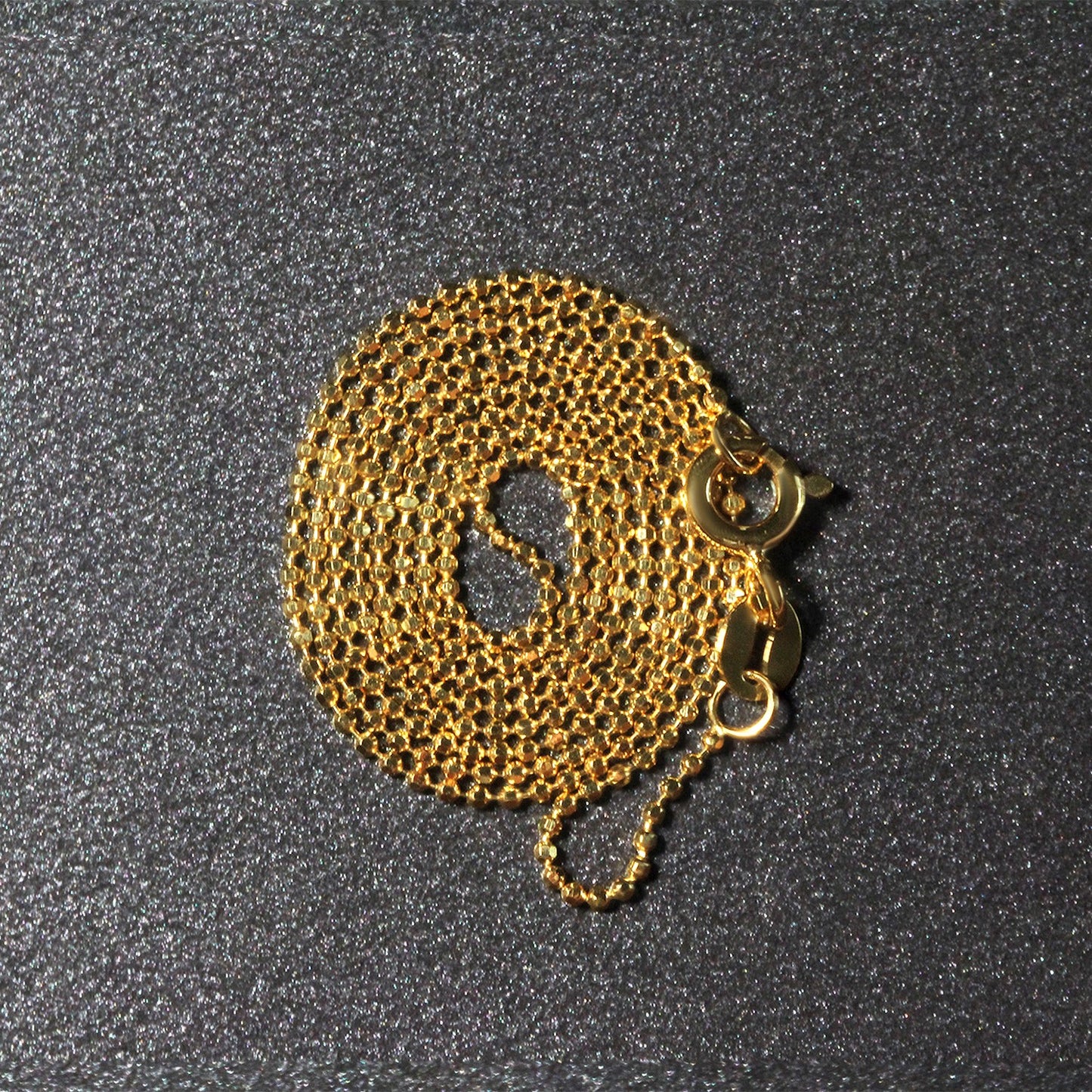 Peelerie jewelry piece in midnight luxury editorial product photo, high-contrast studio lighting