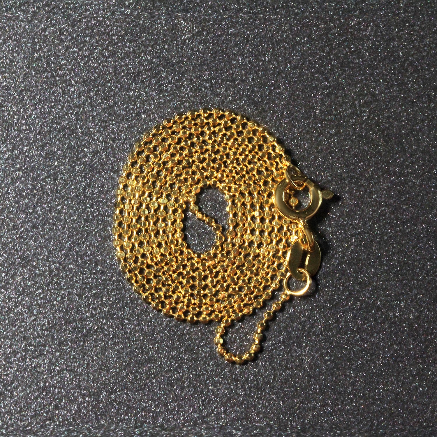 Peelerie jewelry piece in midnight luxury editorial product photo, high-contrast studio lighting