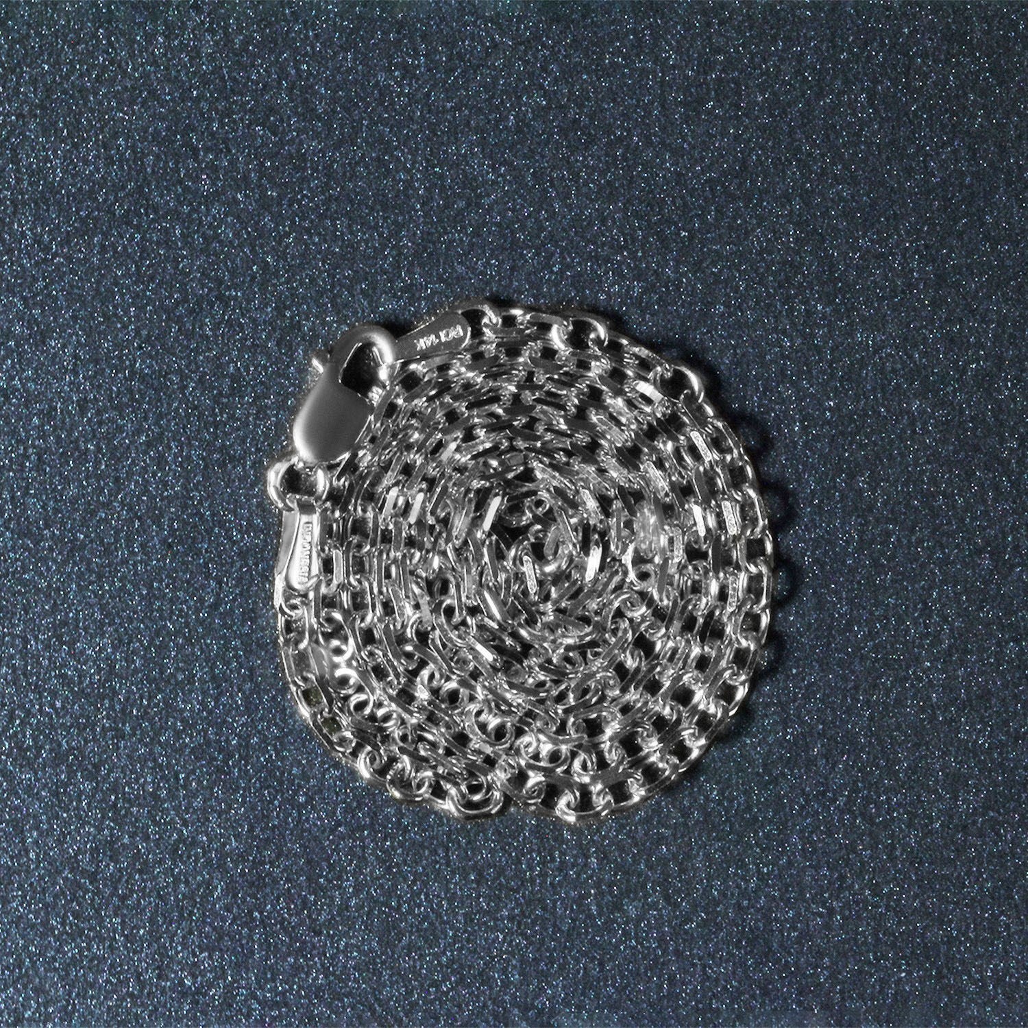 Peelerie jewelry piece in midnight luxury editorial product photo, high-contrast studio lighting