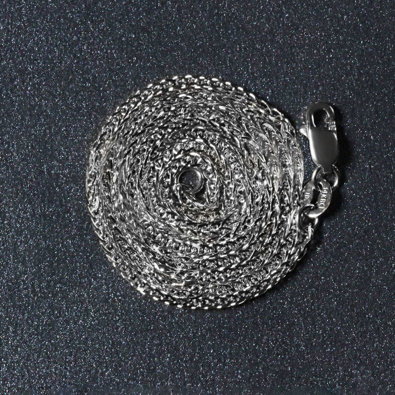 Peelerie jewelry piece in midnight luxury editorial product photo, high-contrast studio lighting