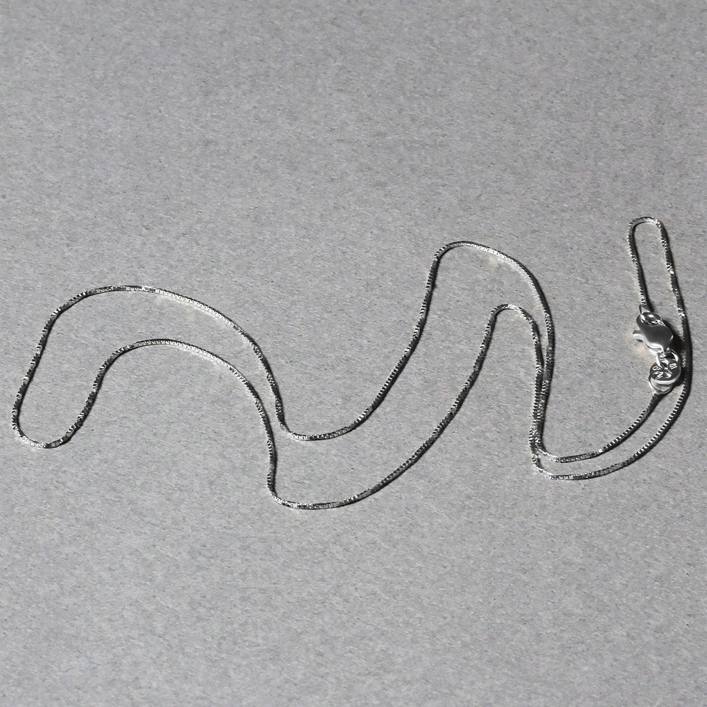 Peelerie jewelry piece in midnight luxury editorial product photo, high-contrast studio lighting