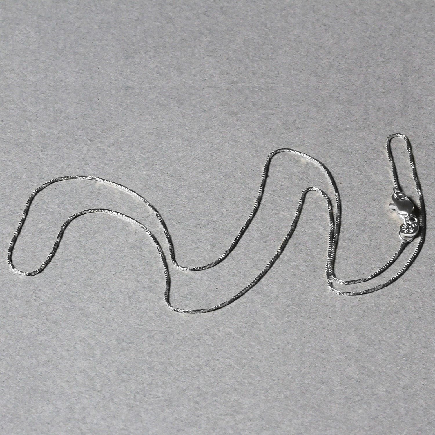 Peelerie jewelry piece in midnight luxury editorial product photo, high-contrast studio lighting