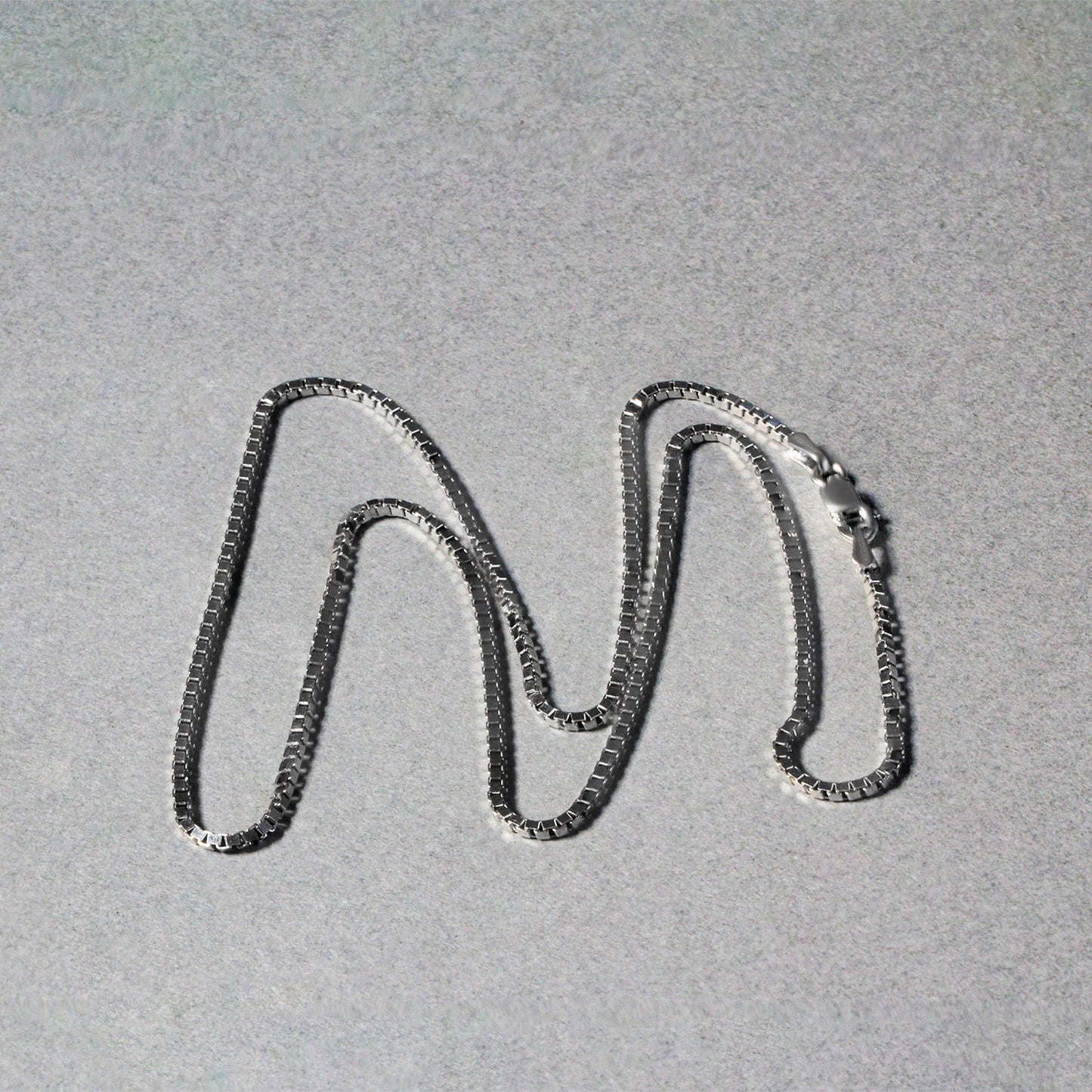 Peelerie jewelry piece in silver midnight luxury editorial product photo, high-contrast studio lighting