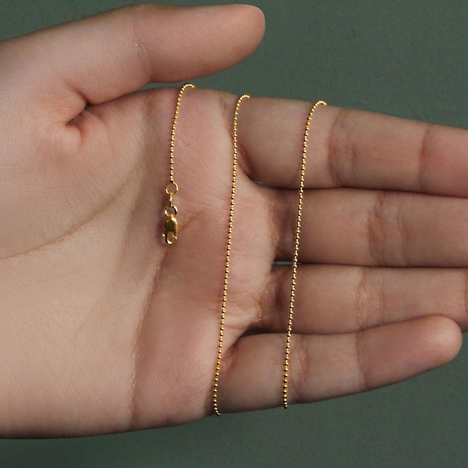 Peelerie jewelry piece in midnight luxury editorial product photo, high-contrast studio lighting