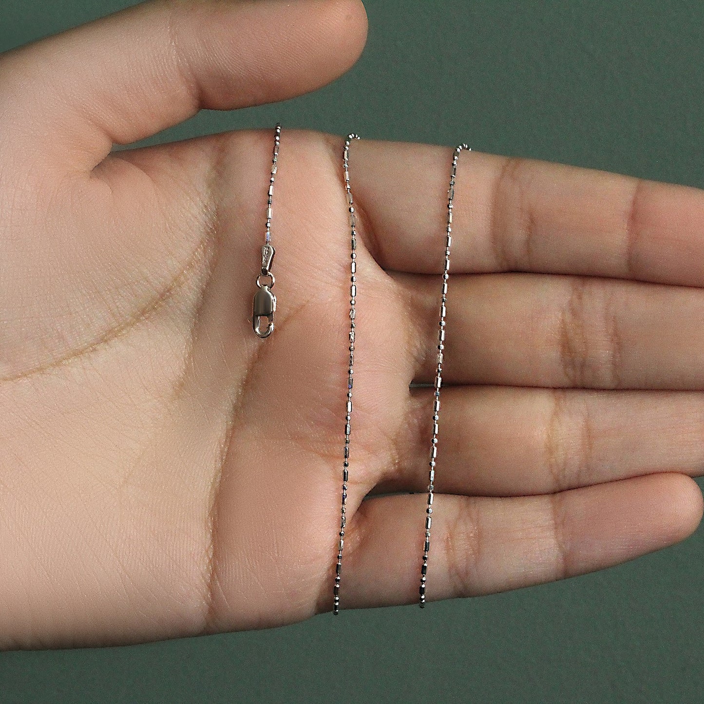 Peelerie jewelry piece in midnight luxury editorial product photo, high-contrast studio lighting