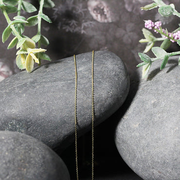 14k Yellow Gold Cable Link Chain (0.50 mm) in a sleek high-contrast midnight luxury editorial style