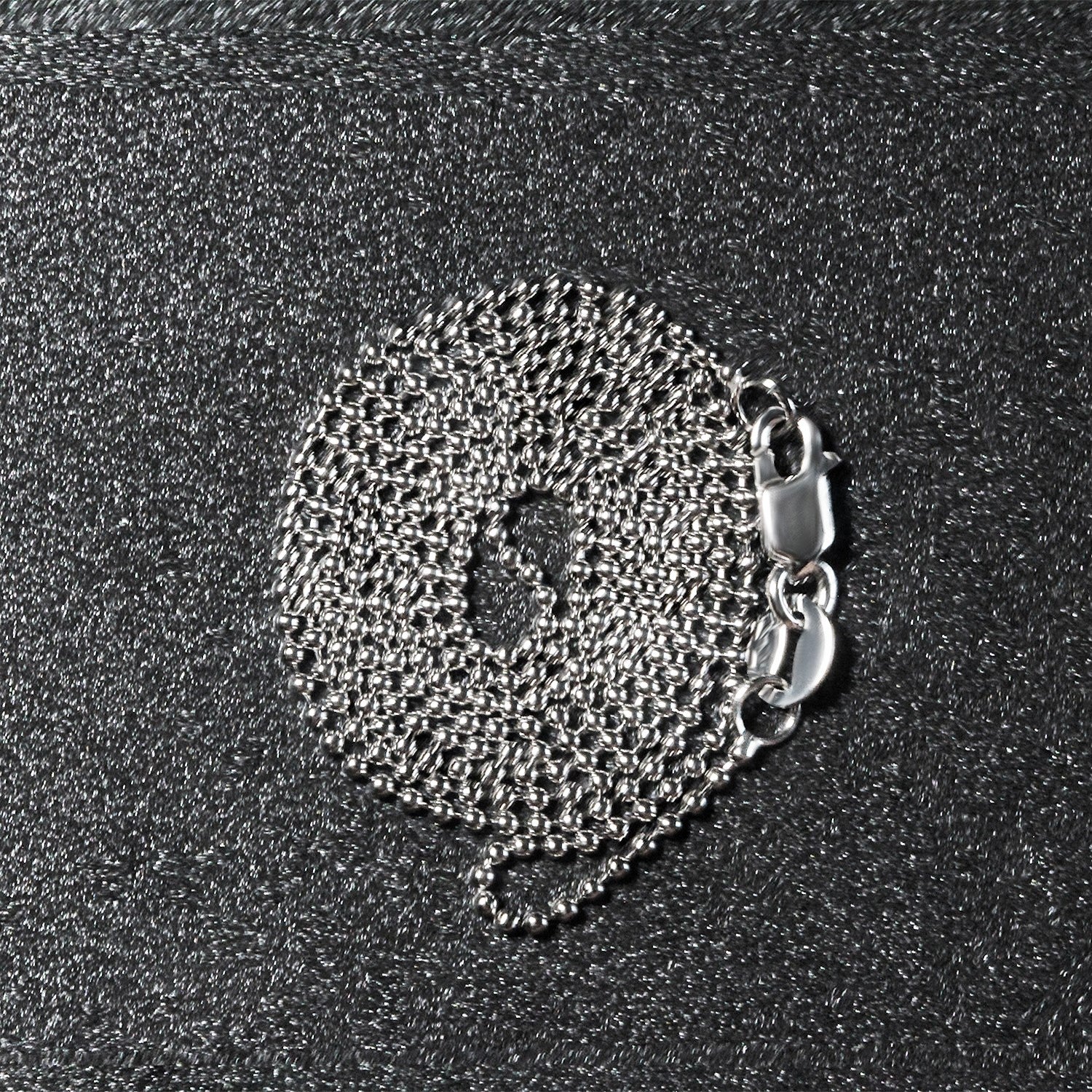 Peelerie jewelry piece in midnight luxury editorial product photo, high-contrast studio lighting