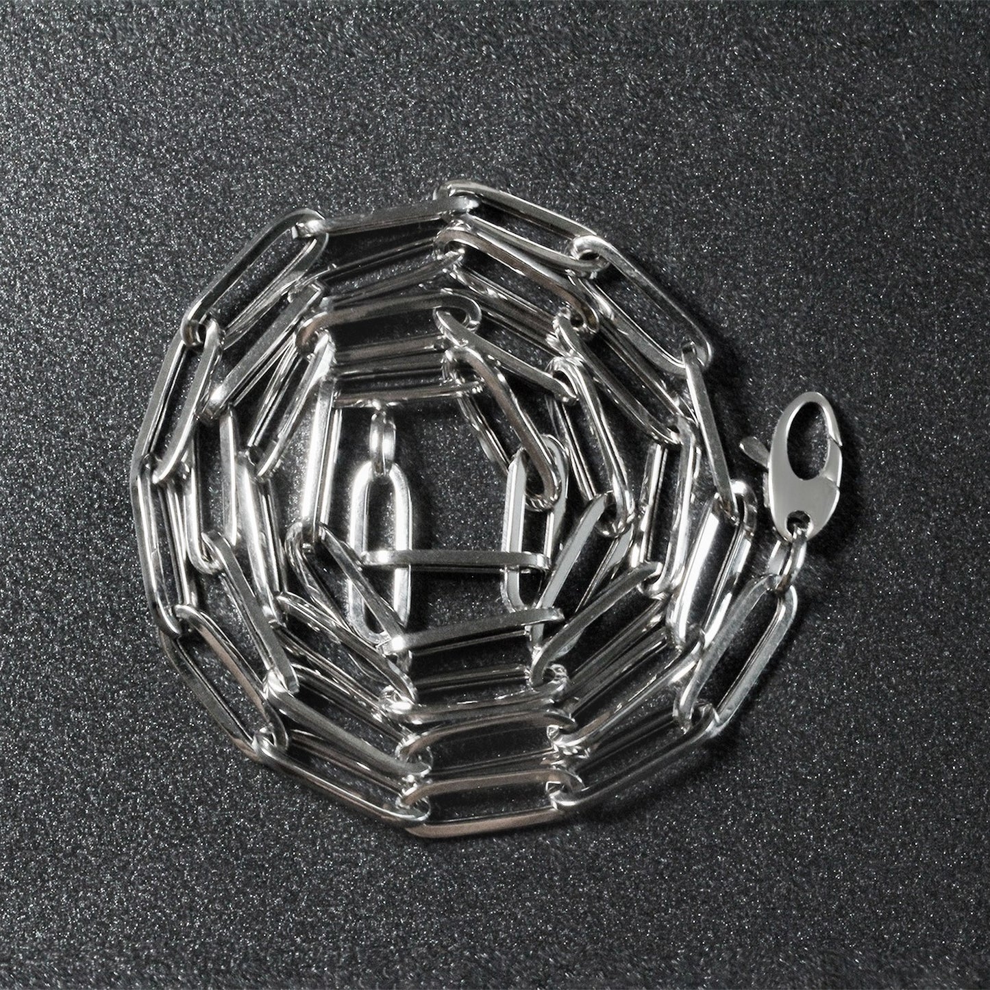 Peelerie jewelry piece in midnight luxury editorial product photo, high-contrast studio lighting