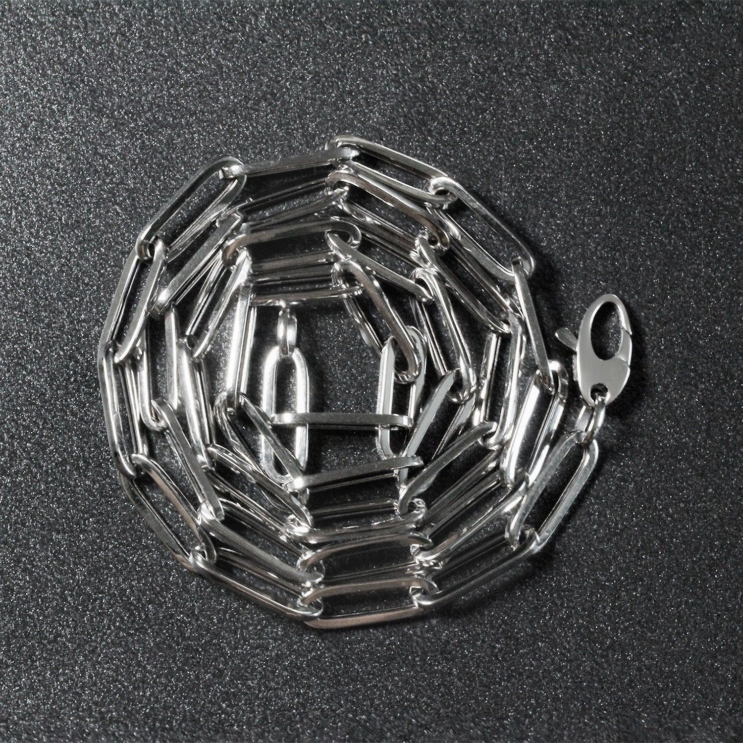 Peelerie jewelry piece in midnight luxury editorial product photo, high-contrast studio lighting