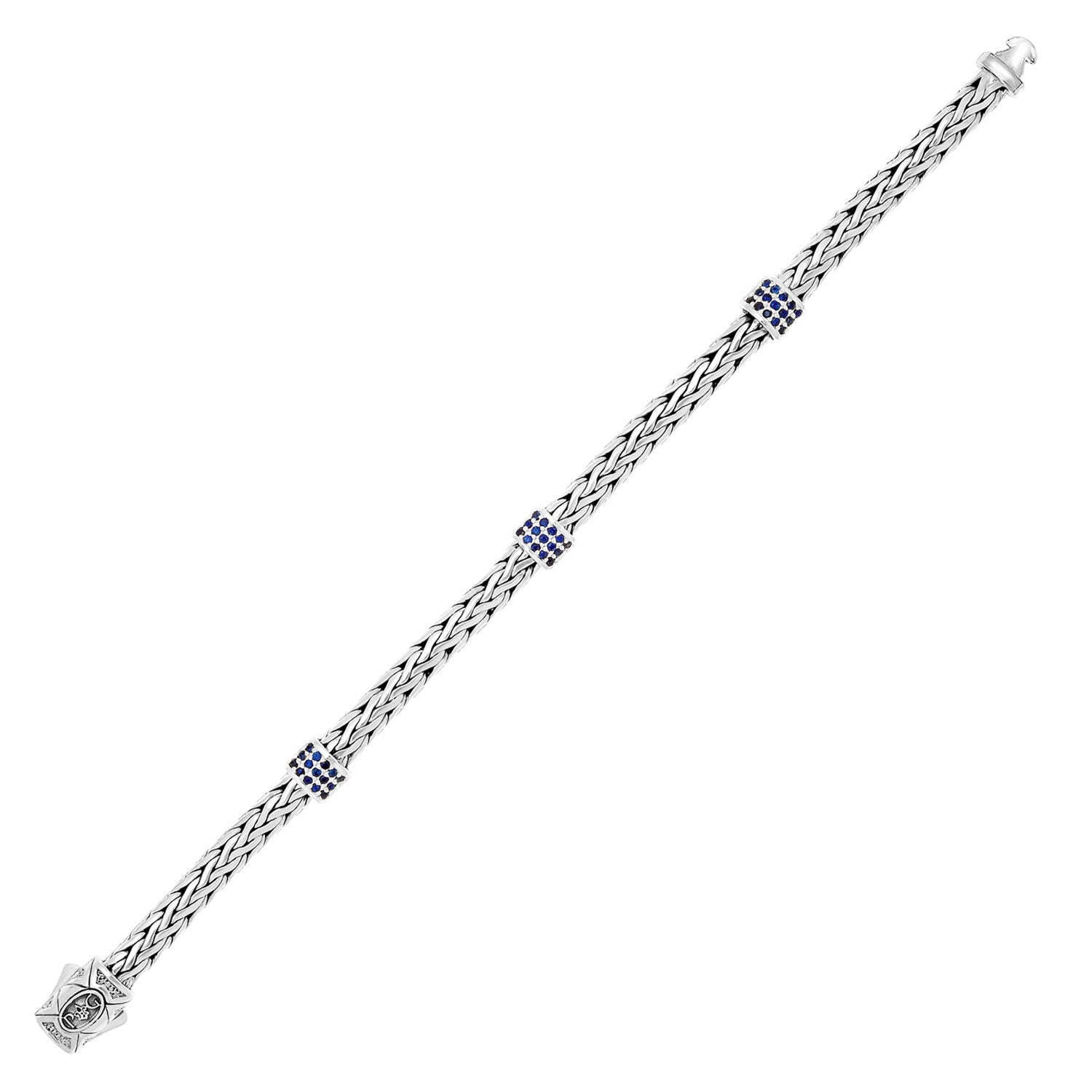 Sterling Silver Woven Bracelet with Blue Sapphire Stations (6.35 mm) in a sleek high-contrast midnight luxury editorial style