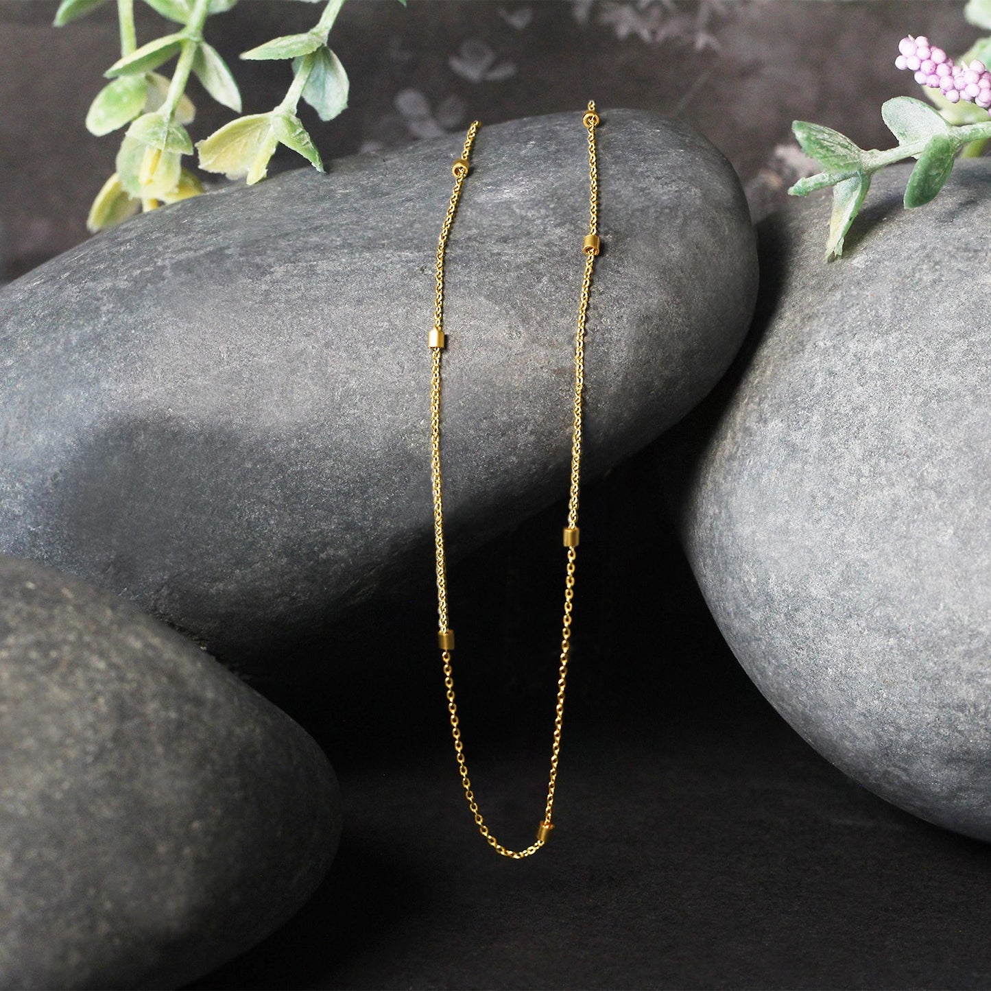 Bead Links Pendant Chain in 14k Yellow Gold (1.50 mm) in a sleek high-contrast midnight luxury editorial style