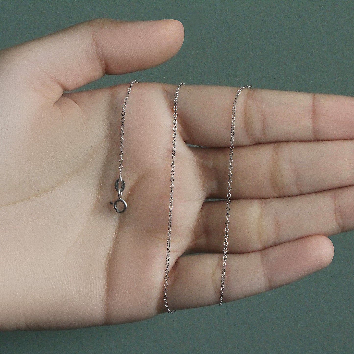 Peelerie jewelry piece in midnight luxury editorial product photo, high-contrast studio lighting