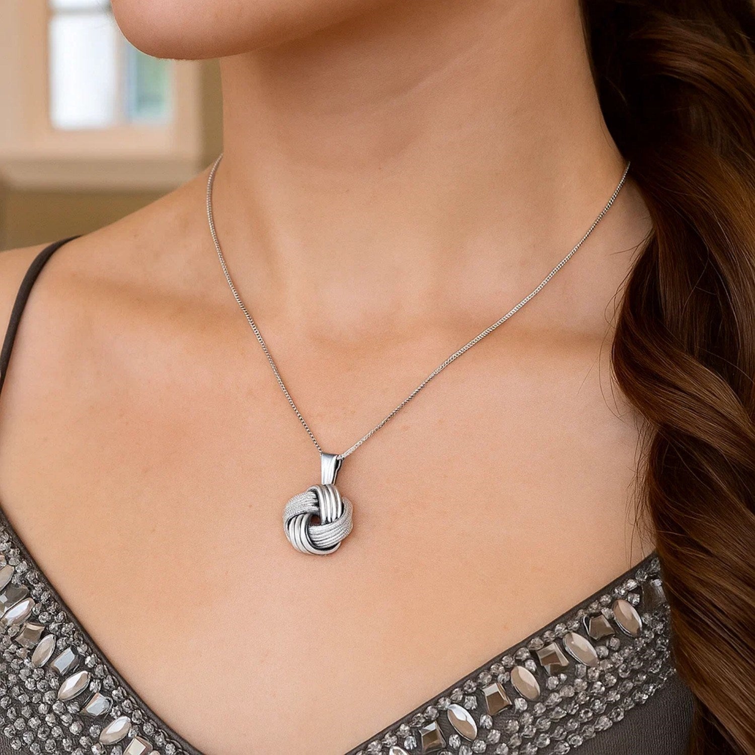 Sterling Silver Pendant with a Ridge Textured Love Knot Design - Peelerie