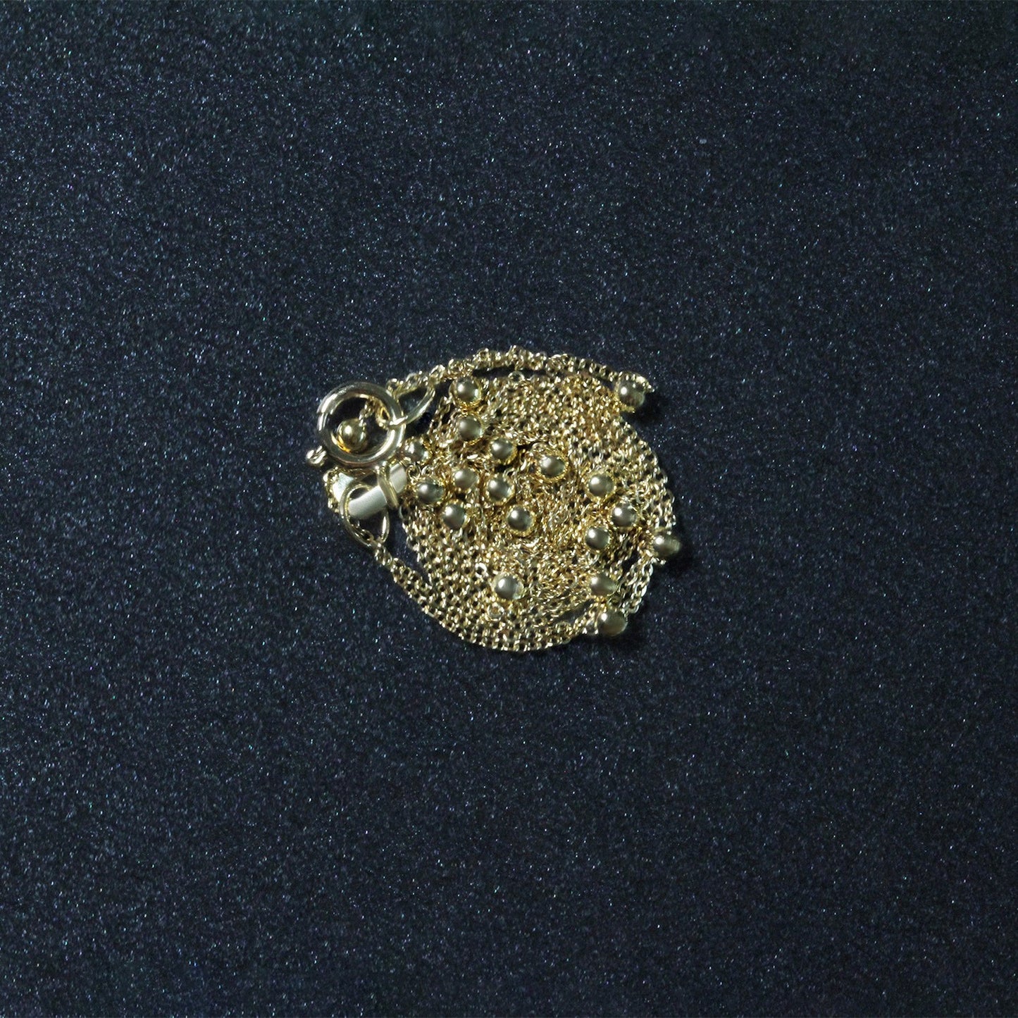 Peelerie jewelry piece in midnight luxury editorial product photo, high-contrast studio lighting