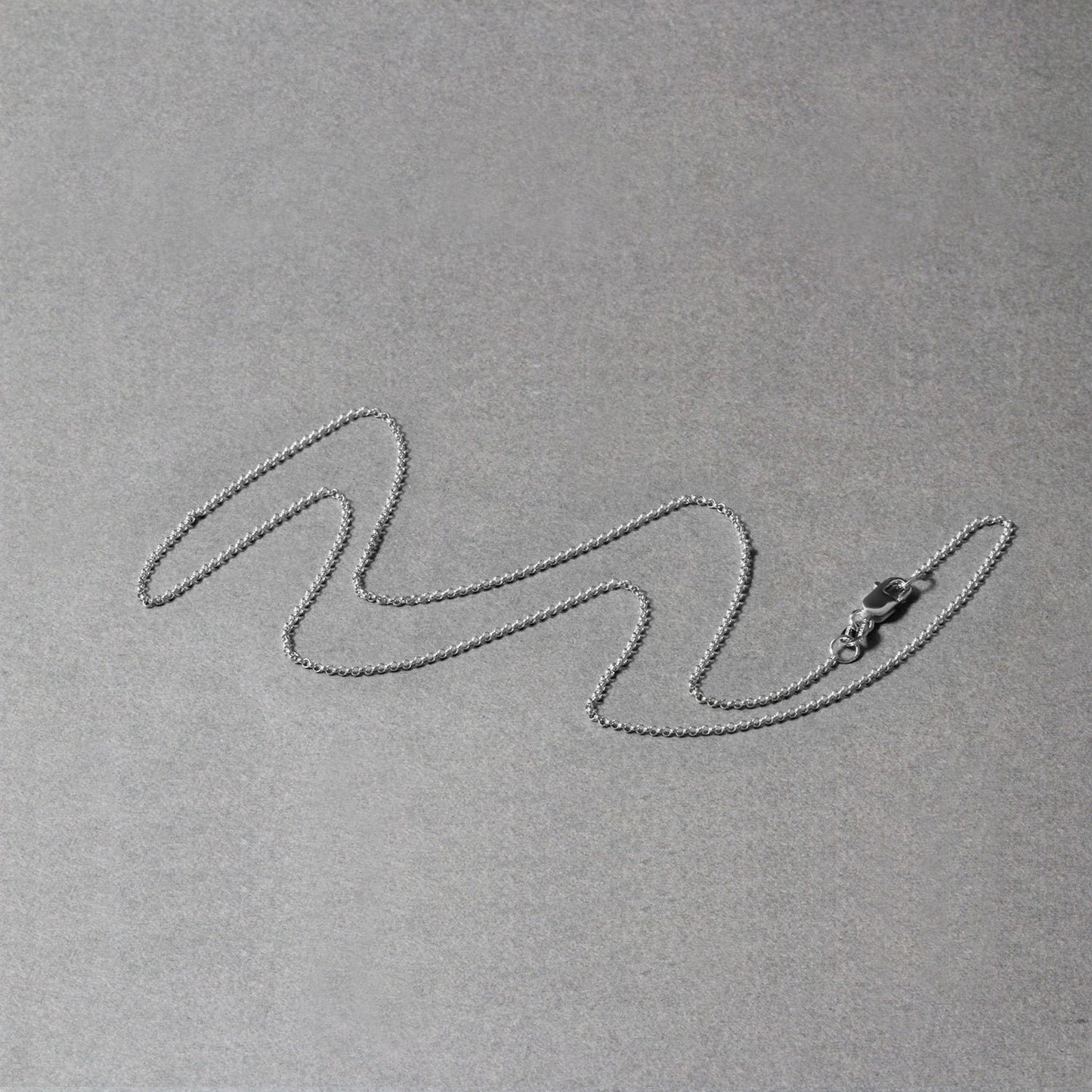 Peelerie jewelry piece in midnight luxury editorial product photo, high-contrast studio lighting