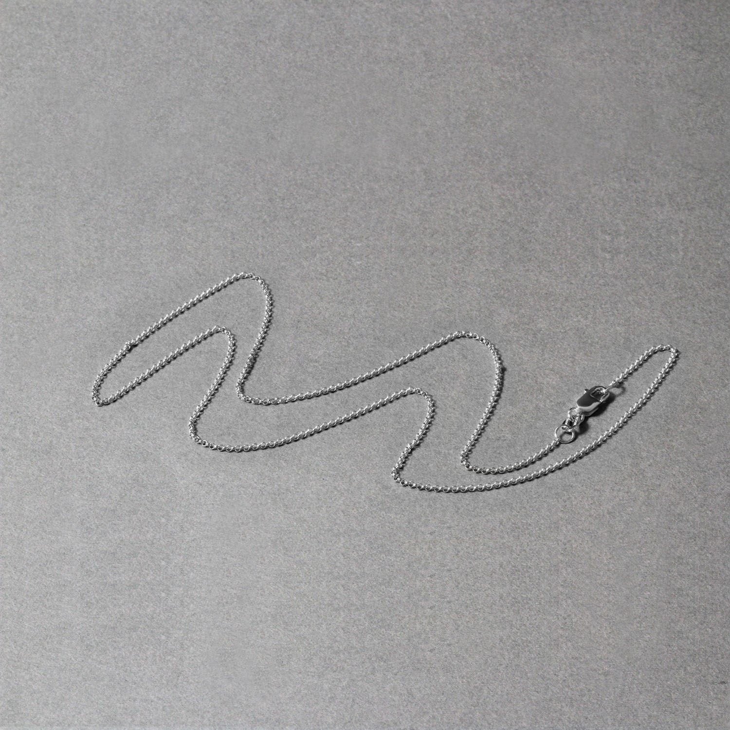 Peelerie jewelry piece in midnight luxury editorial product photo, high-contrast studio lighting