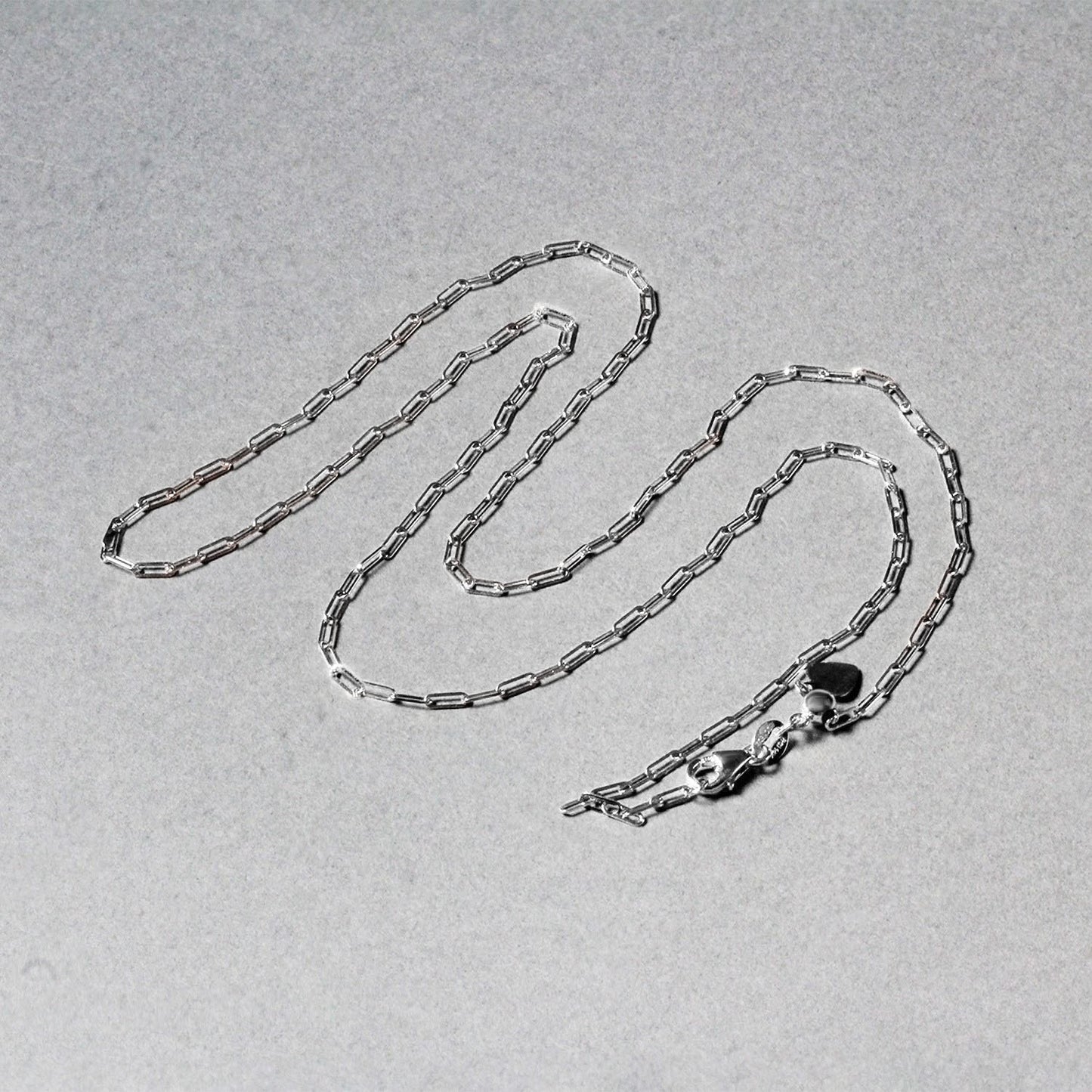 Peelerie jewelry piece in midnight luxury editorial product photo, high-contrast studio lighting