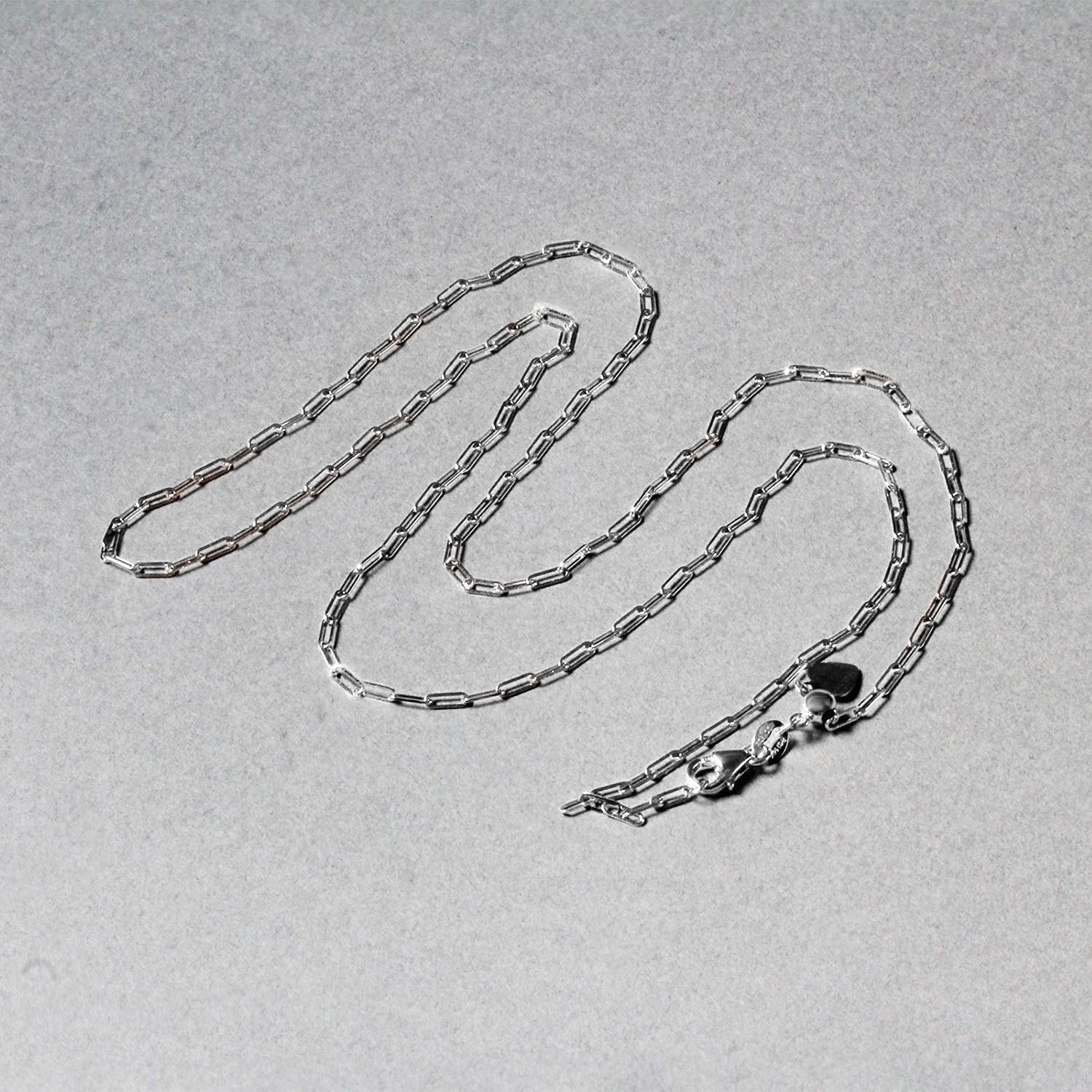 Peelerie jewelry piece in midnight luxury editorial product photo, high-contrast studio lighting