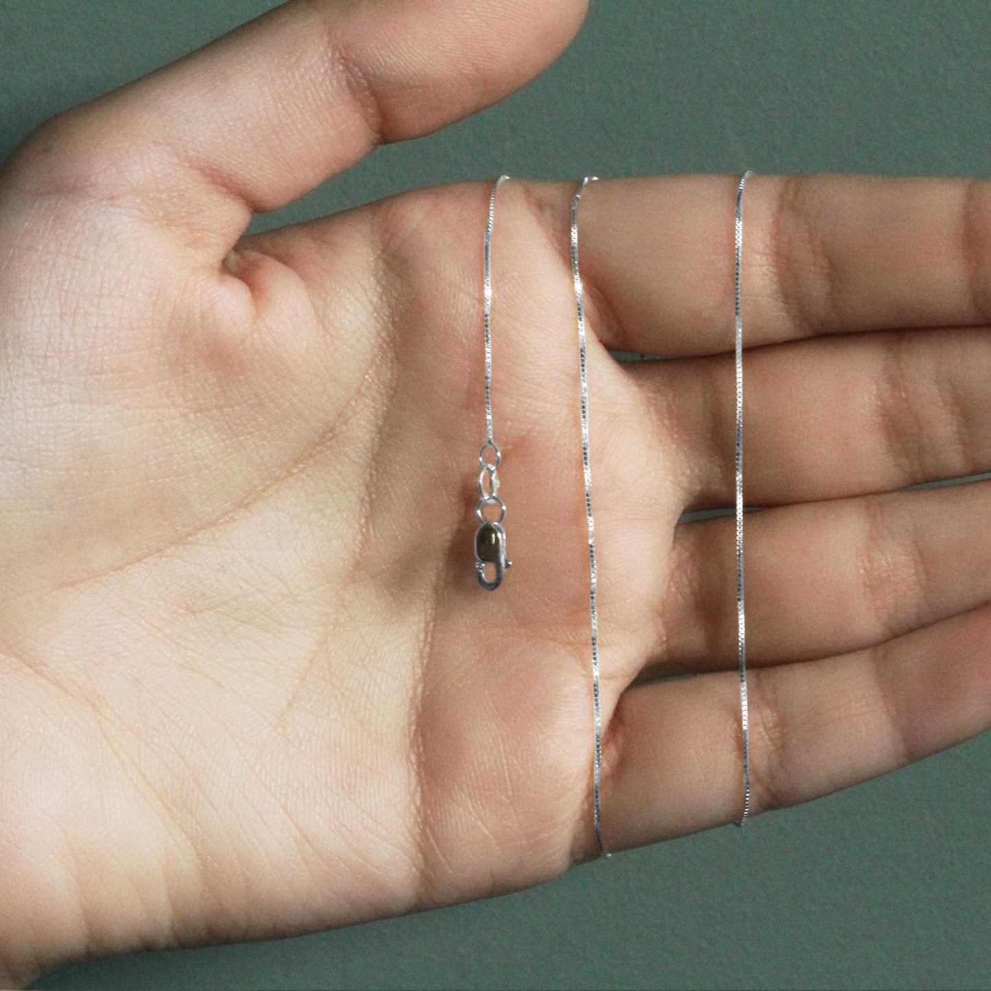 Peelerie jewelry piece in midnight luxury editorial product photo, high-contrast studio lighting