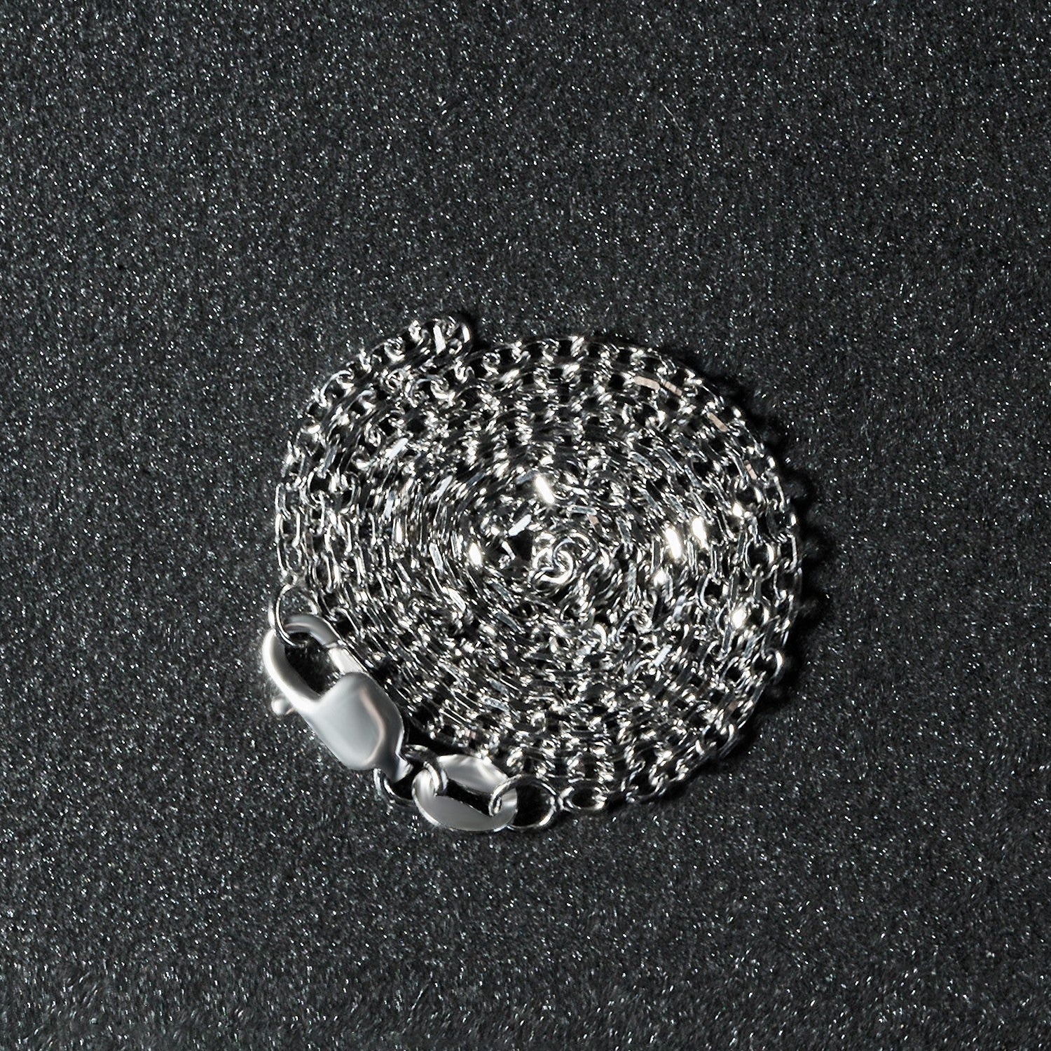 Peelerie jewelry piece in midnight luxury editorial product photo, high-contrast studio lighting