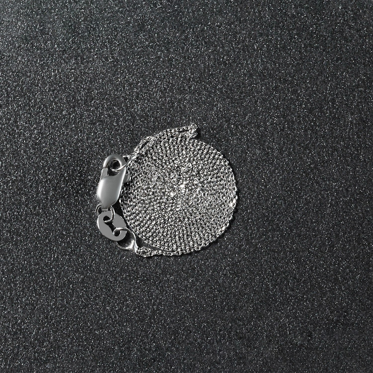 Peelerie jewelry piece in midnight luxury editorial product photo, high-contrast studio lighting