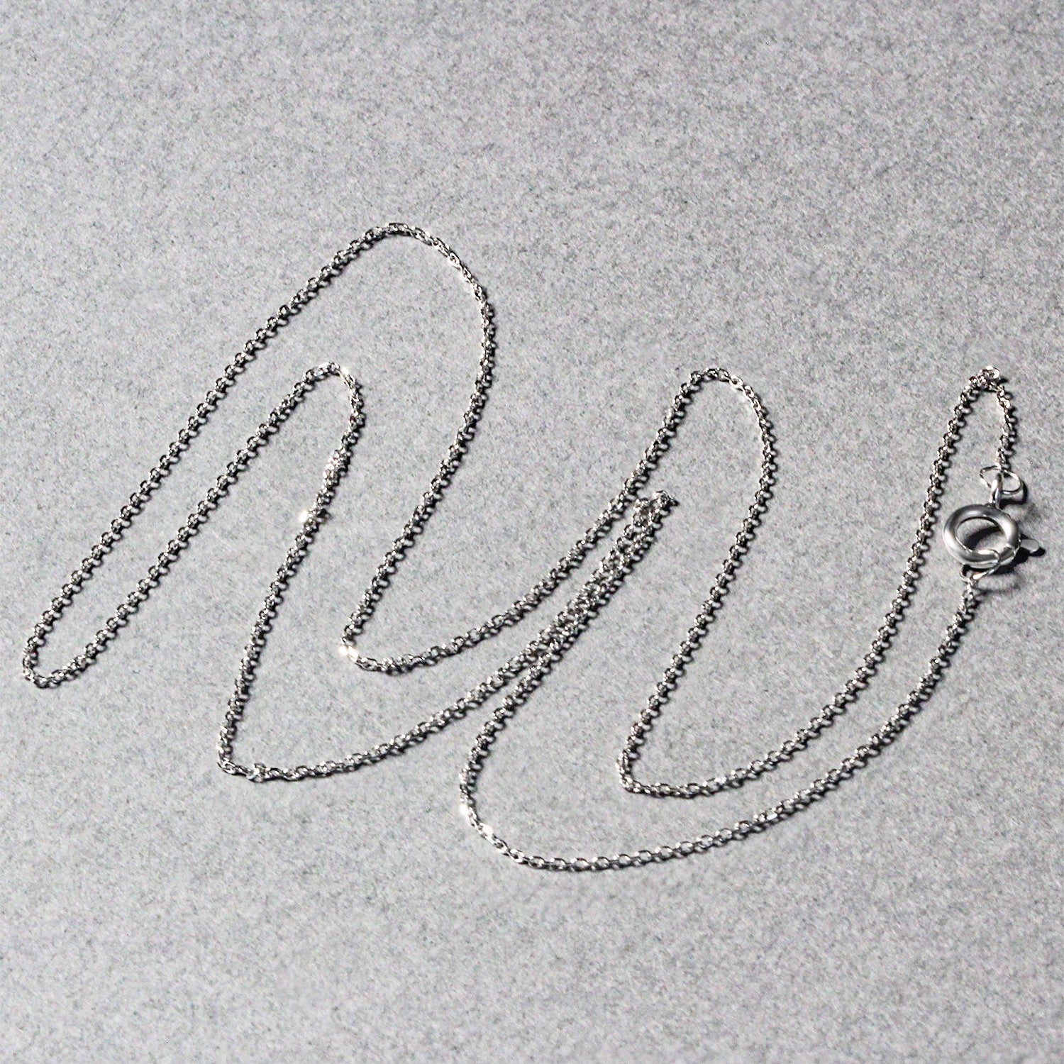 Peelerie jewelry piece in midnight luxury editorial product photo, high-contrast studio lighting