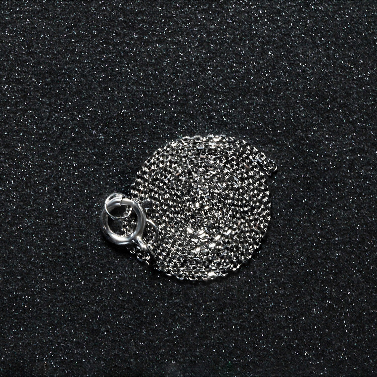 Peelerie jewelry piece in midnight luxury editorial product photo, high-contrast studio lighting