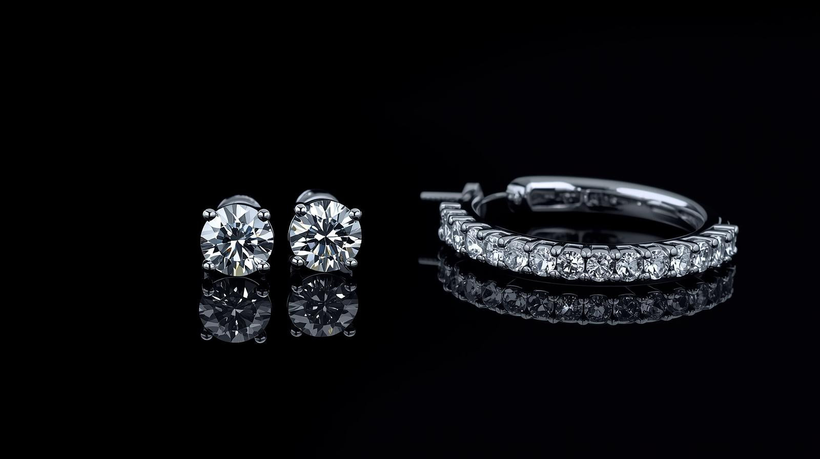Diamond earrings on a black reflective surface