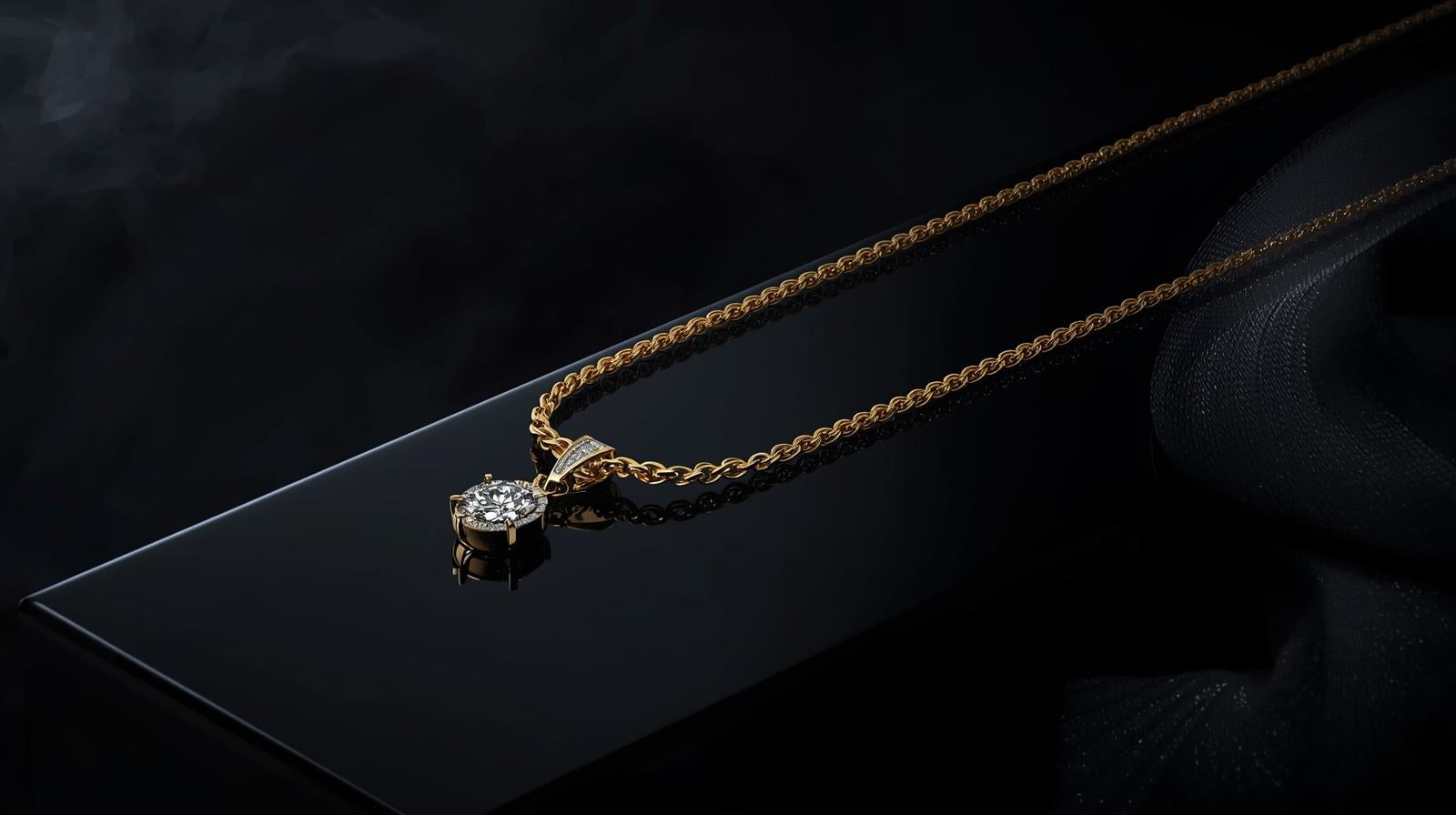 Gold necklace with a diamond pendant on a dark surface
