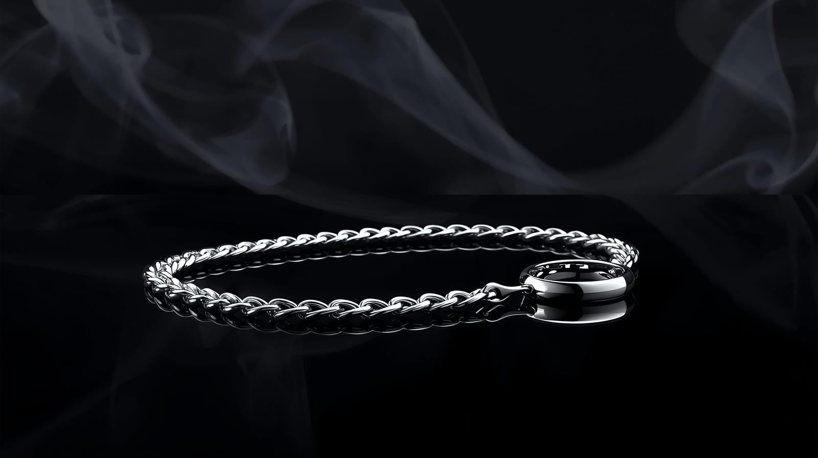 Silver chain bracelet on a dark background with smoke effect