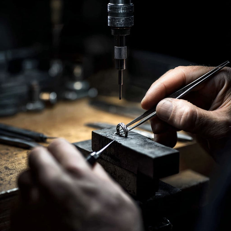 A jeweller finishing a piece by hand